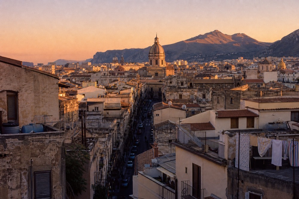 Sunset over Palermo's rooftops and the dome of the cathedral, seen from a high terrace