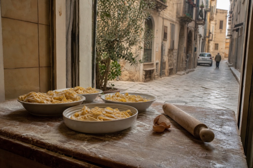 Bowls of fresh egg pasta tortellini on a wooden counter in an Italian shop