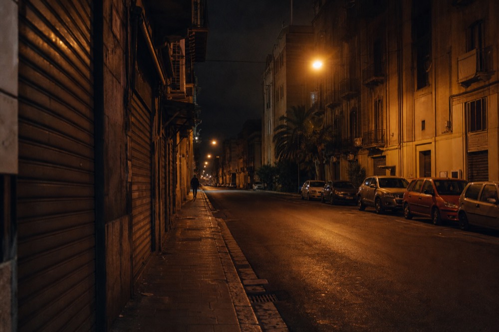 Evening street near Palermo Centrale station with closed shutters and sparse lighting