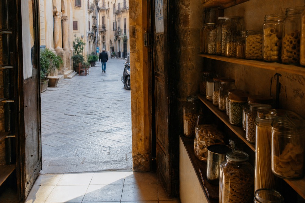Dried pasta shapes and legumes displayed in a Palermo shop window